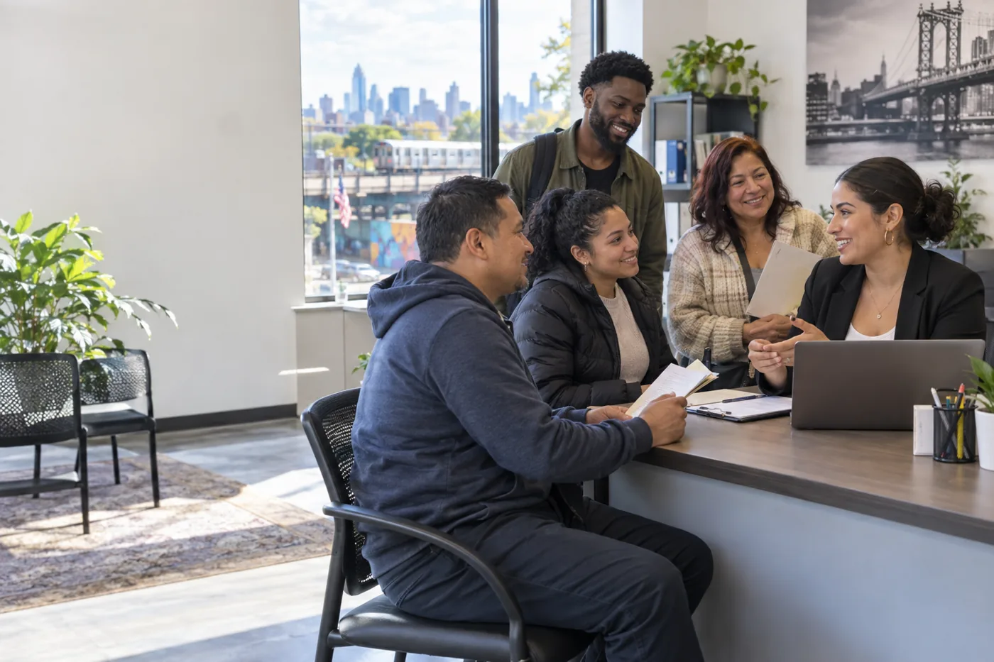 A diverse group meets with a career adviser in Queens